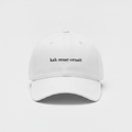 White cap with small black kak-maar-oraait front print